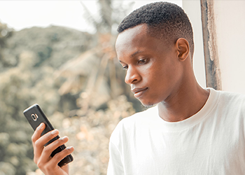 A young man looking at his phone