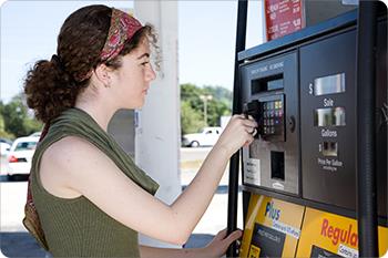Girl swipes her card at gas station