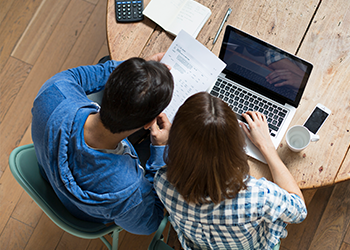 Two people looking at a computer together