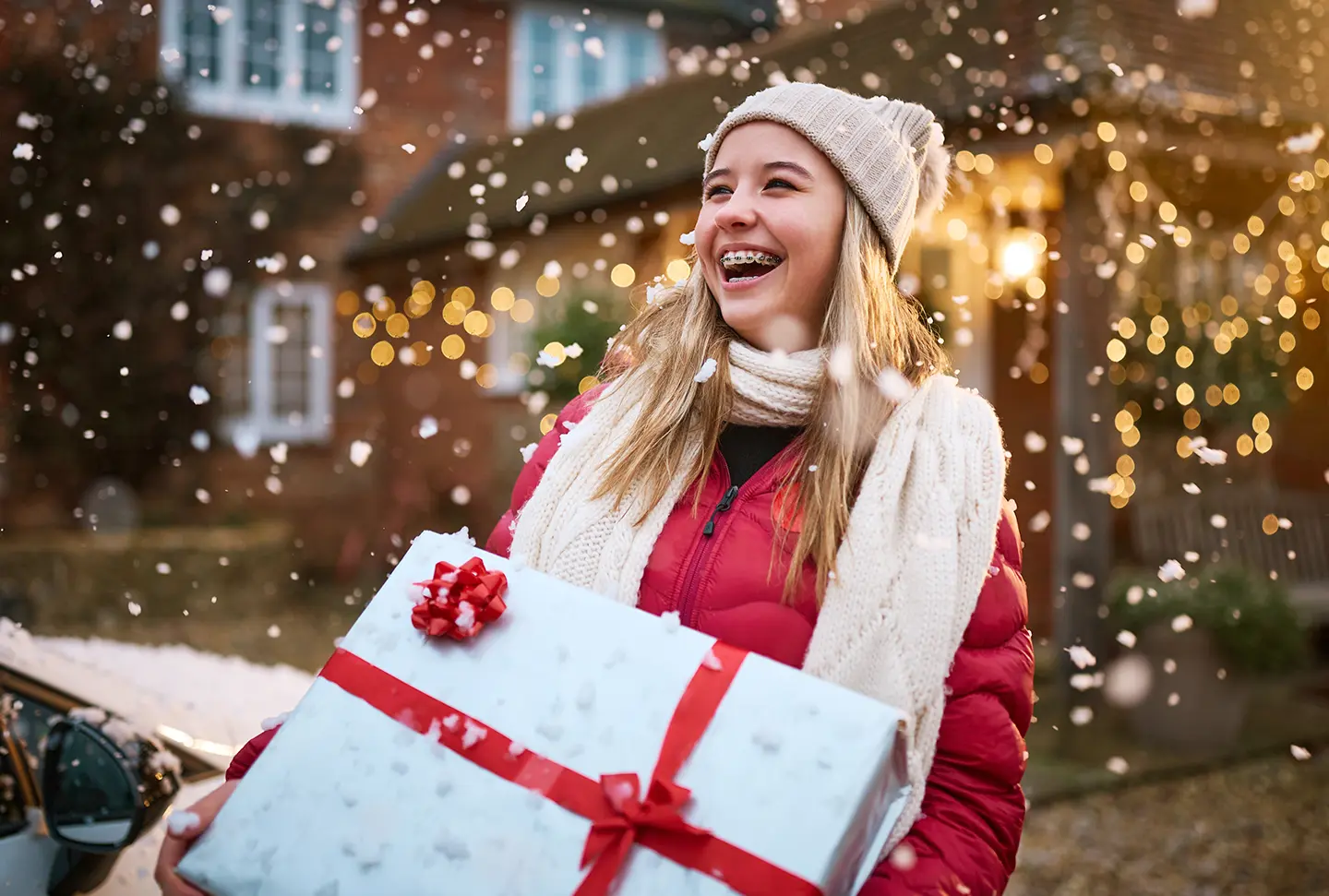 A teenager holding a present and smiling