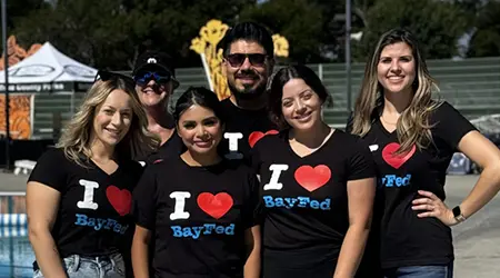 Six employees smiling