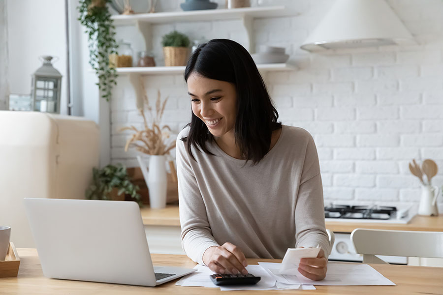 Young women paying bills online. 