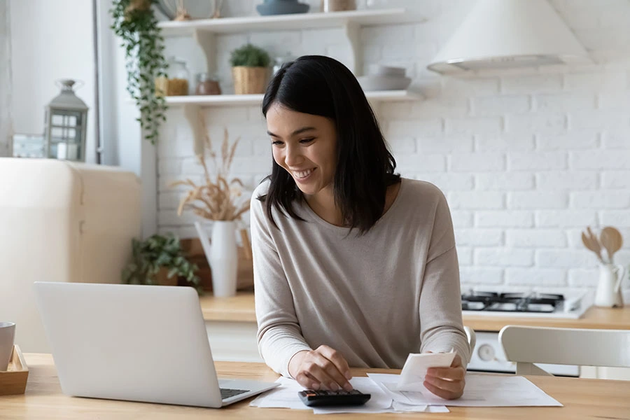 Young women paying bills online.